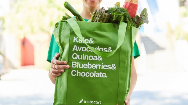 Green shopping bag with Instacart logo and the inscription "Kale & Avocados & Quinoa & Blueberries & Chocolate."
