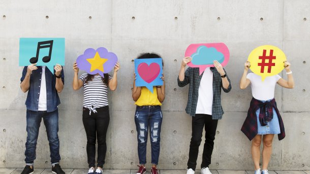 Teenagers,Covering,Their,Faces,With,Social,Media,Icons