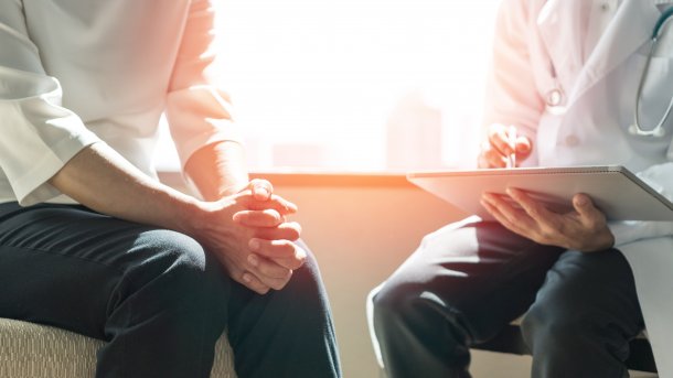 Zwei Personen, die sich im Gespräch gegenüber sitzen