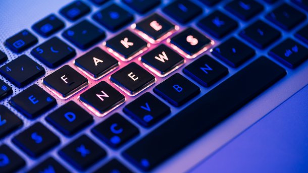 Fake,News,Written,In,Red,On,A,Backlit,Laptop,Keyboard