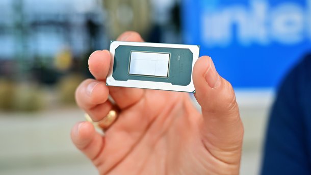 Hand holding a bare Intel processor