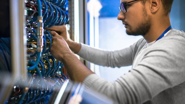 Side,View,Portrait,Of,Young,Man,Wearing,Glasses,Connecting,Cables