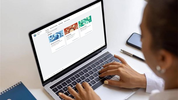 Photo of a person sitting at a computer displaying the Federal Data Atlas