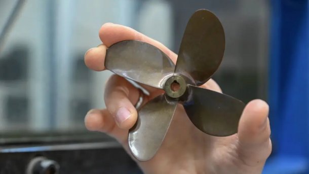 Ship propeller in one hand.