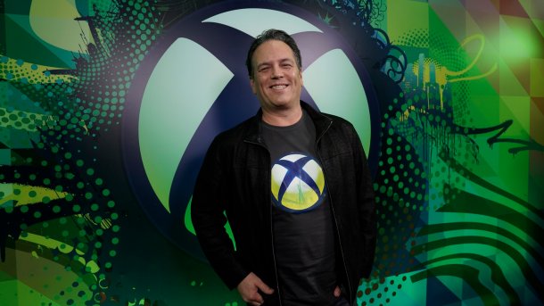 Phil Spencer in front of Xbox logo