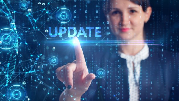 Eine Frau drückt einen symbolsichen Updateknopf. 