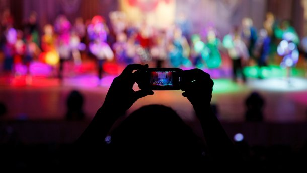 People,Holding,Their,Smart,Phones,Shooting,Video,Or,Photo.