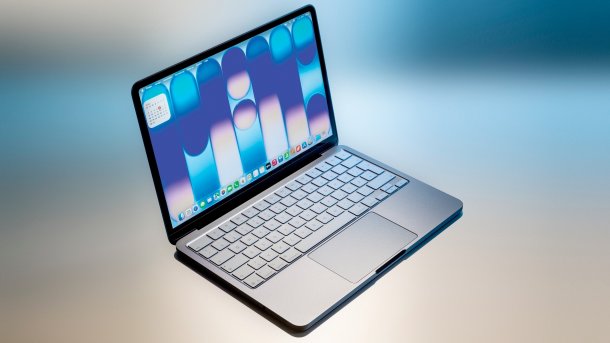 Open MacBook Neo against a colorful background