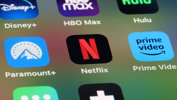 Close-up of a smartphone display showing apps from various streaming services.