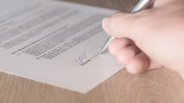 Someone signs a contract
