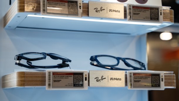 Ray-Ban Meta Smart-Glasses in a store. Several models lie on illuminated shelves.