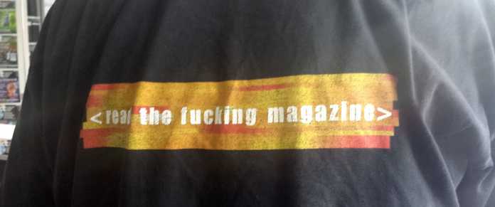 Mahnend steht es auf dem T-Shirt des Kollegen: Read The Fucking Magazine.