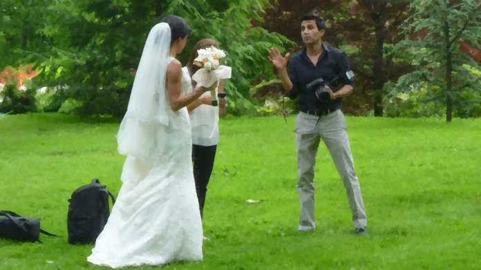 Eine Braut wird in einem Park fotografiert