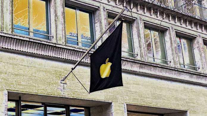 Illustration zeigt eine schwarze Fahne mit güldenem Apple-Logo