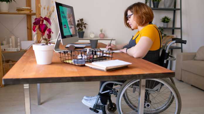 Young,Disable,Woman,In,Wheelchair,Making,Notes,In,Front,Of
