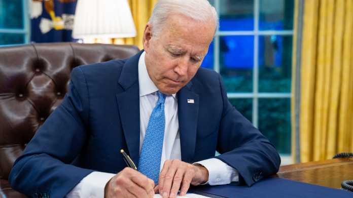  President Joe Biden signs the Emergency Reparation Assistance for Returning Americans Act, Tuesday, August 31, 2021, in the Oval Office of the White House. 