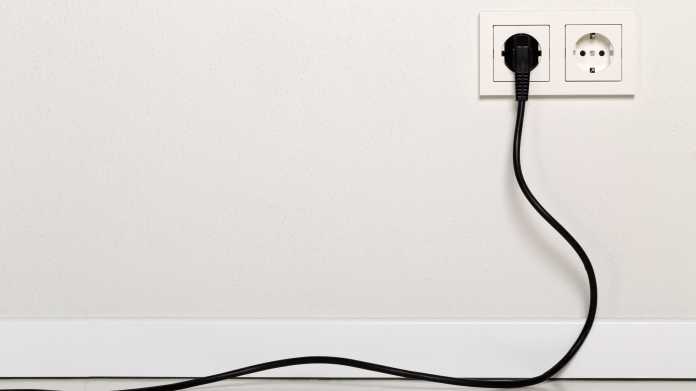 Black,Power,Cord,Cable,Plugged,Into,European,Wall,Outlet,On