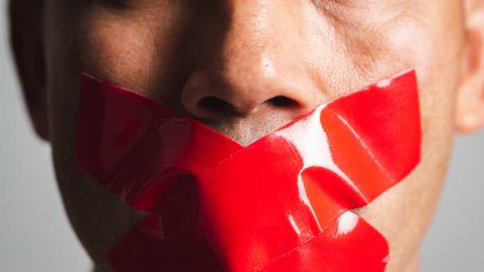 Man,Is,Silenced,With,Adhesive,Red,Tape,Across,His,Mouth