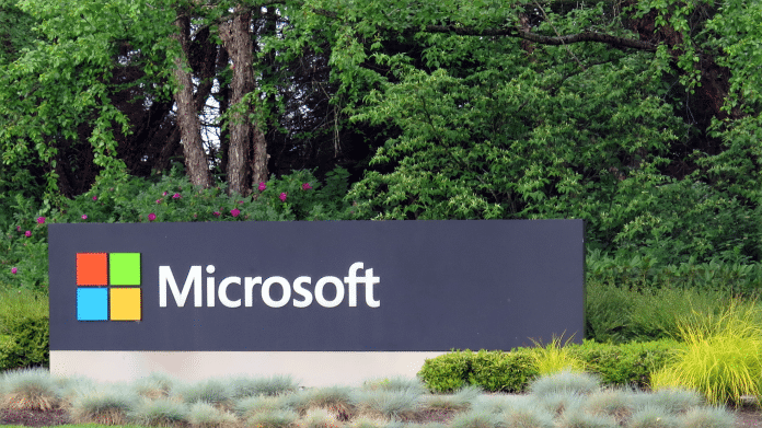 Schild "Microsoft" an Einfahrt zu Firmencampus, dahinter Bäume