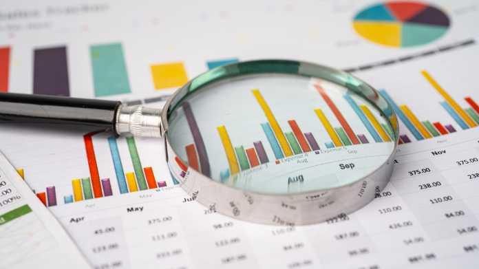 Magnifying,Glass,On,Charts,Graphs,Paper.,Financial,Development,,Banking,Account,