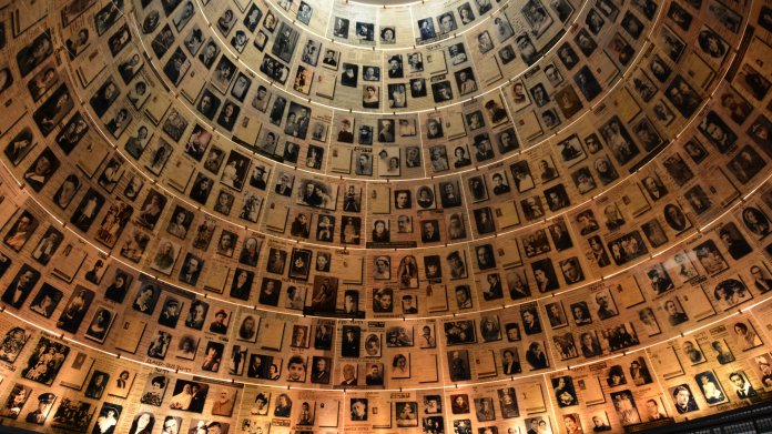 Innenansicht eines runden Turms, dessen Wand mit Fotos ausgekleidet ist.
