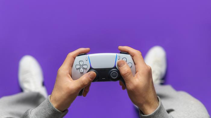 Hand,Hold,New,Joystick.,Gamer,Play,Game,With,Gamepad,Controller.