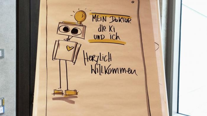 Robot drawing on a sheet of paper. It says 