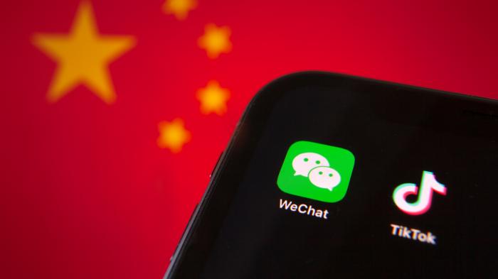 App icons Wechats and Tiktoks on a cell phone screen, with the flag of the People's Republic of China behind them