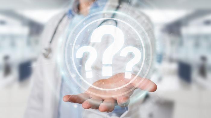 Doctor with a question mark in his hand