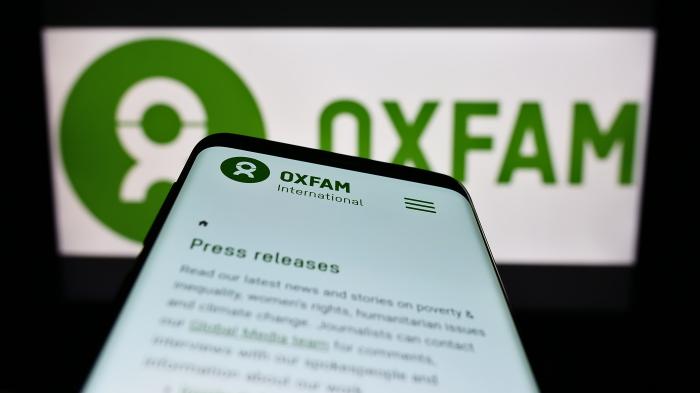 Ein Handy zeigt auf das Oxfam-Logo