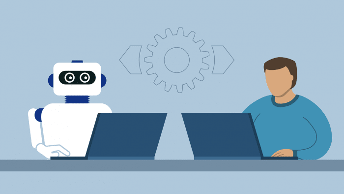 Schreibtisch mit Mensch und Roboter vor Laptop