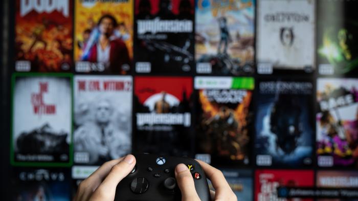 Xbox gamepad in front of screen with game library