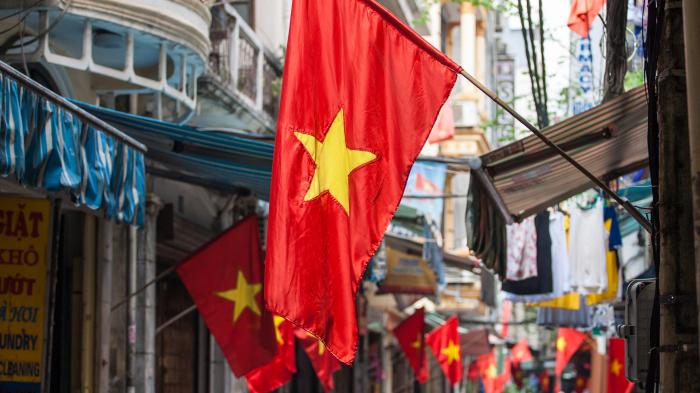 Vietnamese flags above stores in Hanoi's old town