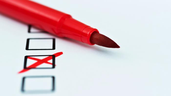 Red felt-tip pen on paper with checkboxes marked