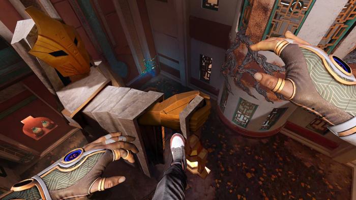 First-person view of a person jumping into an abyss in an ancient temple.